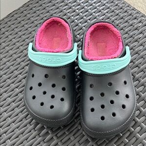 CROCS Black and Pink fuzzy slip ons